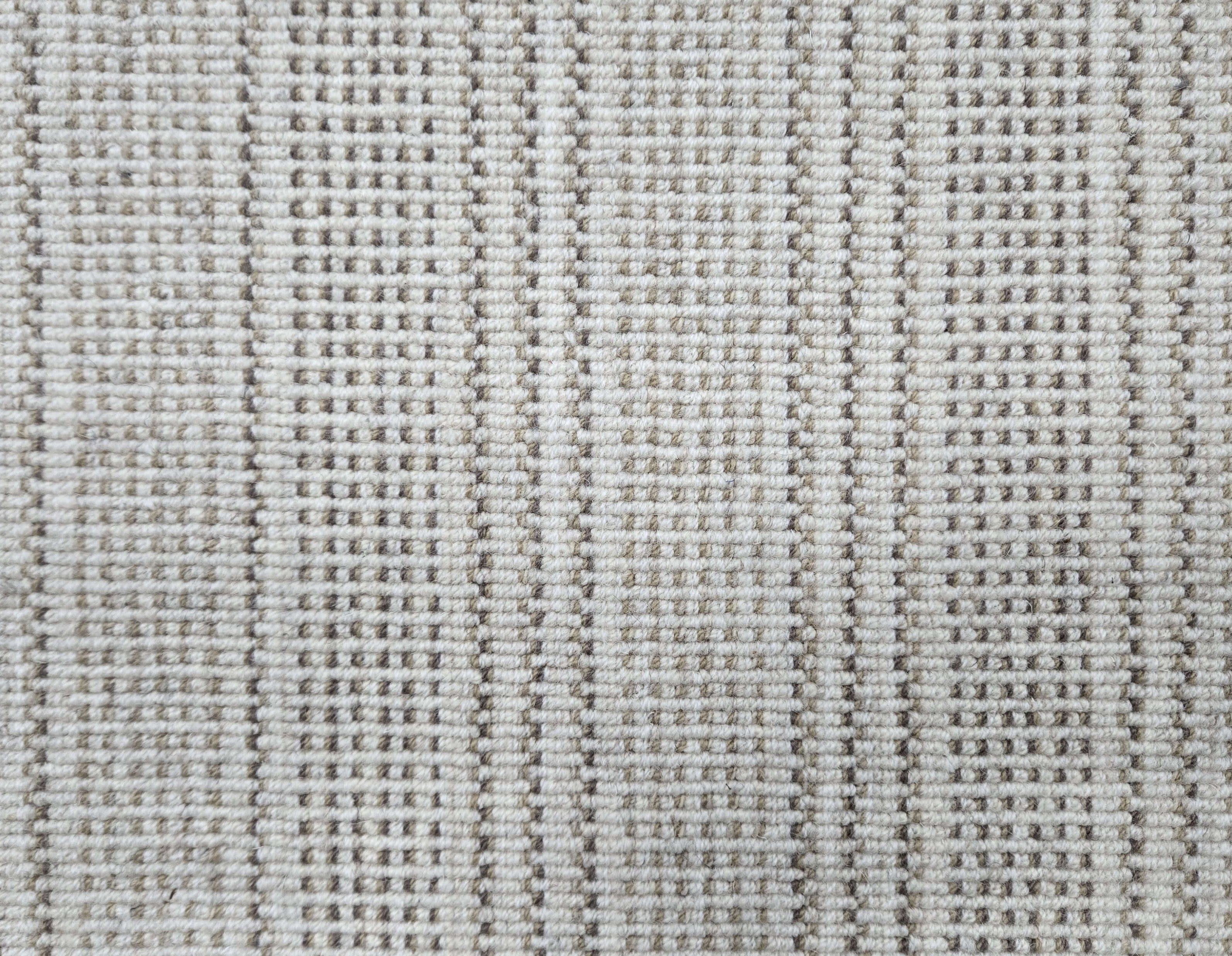Broadloom carpet in dashed stripe pattern in shades of taupe with cream. 