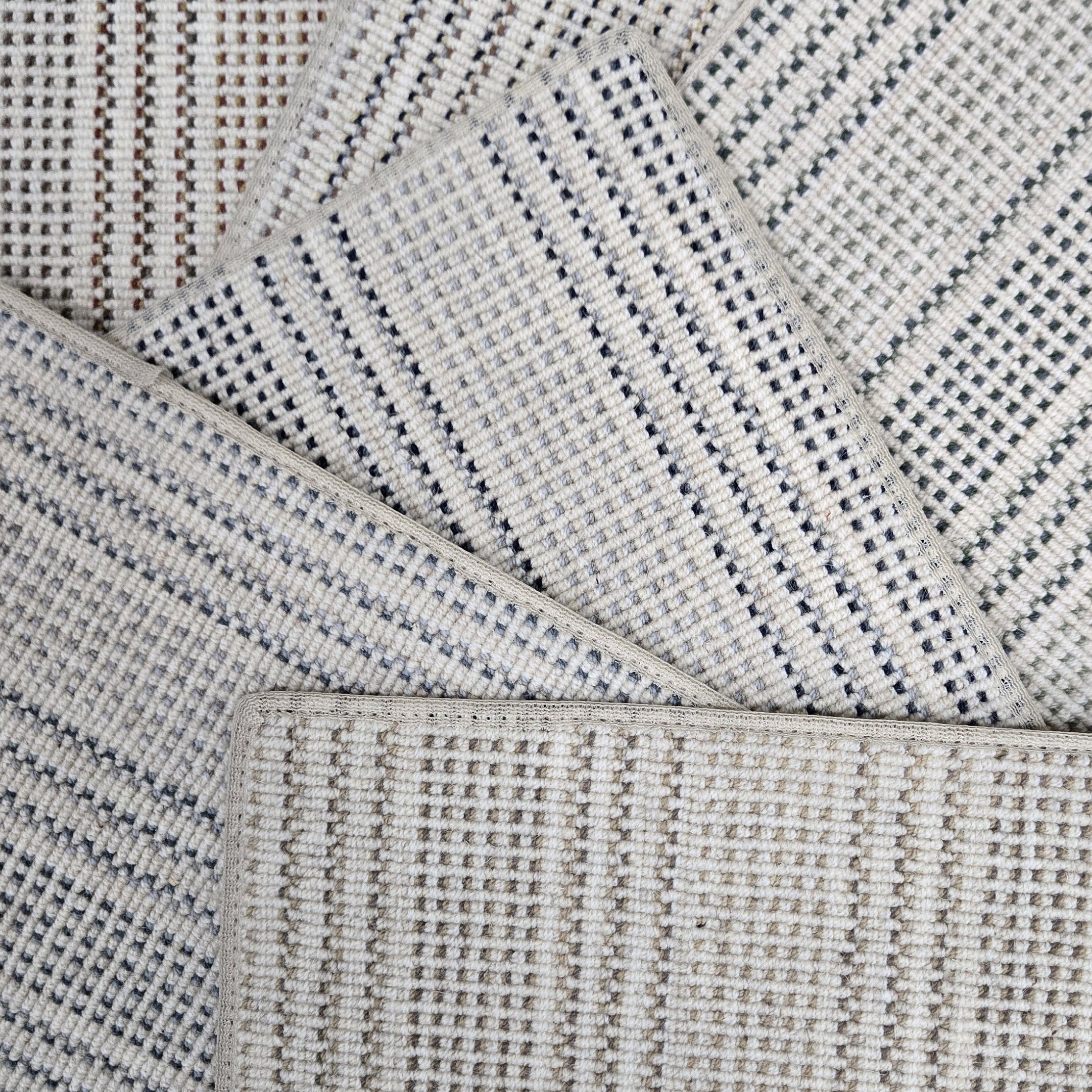 Broadloom carpet samples in a stripe pattern in a range of neutral colors. 