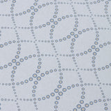 Detail of a wallpaper in a playful floral lattice print in navy blue and tan on a white field.