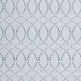 Wallpaper in a playful floral lattice print in navy blue and tan on a white field.