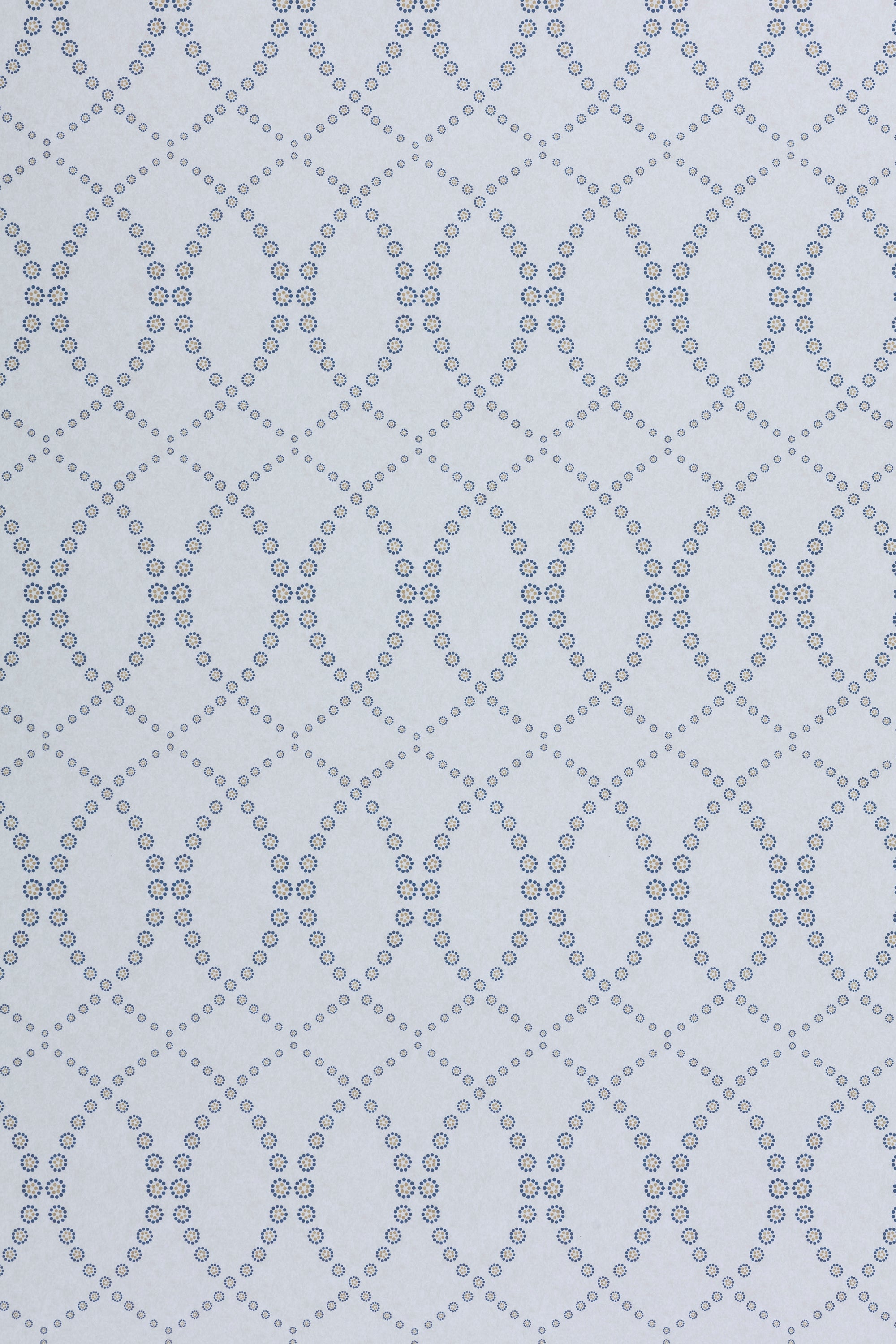 Wallpaper in a playful floral lattice print in navy blue and tan on a white field.