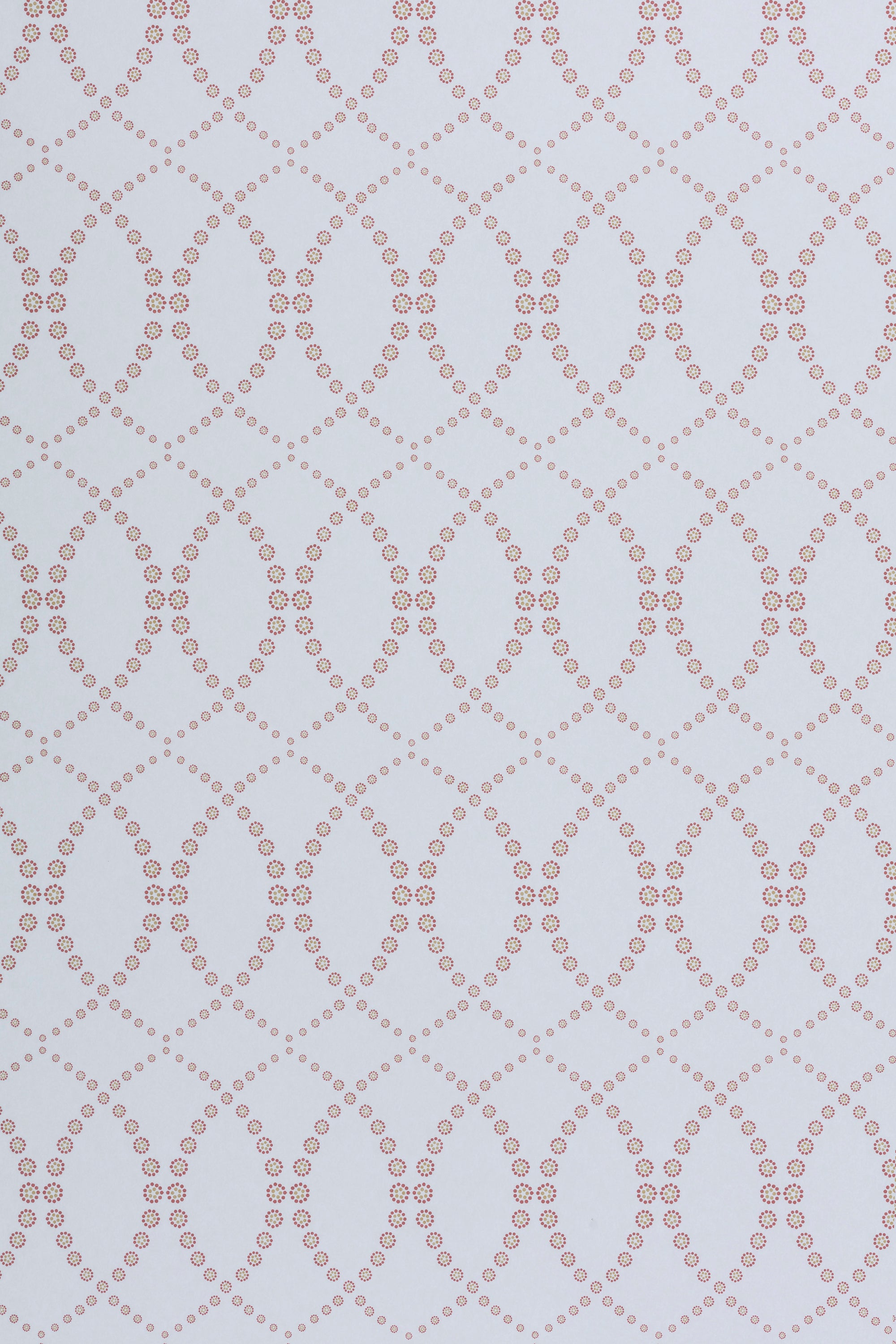 Wallpaper in a playful floral lattice print in tan and rust red on a white field.