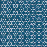 Wallpaper in a floral lattice print in cream on a indigo blue field.