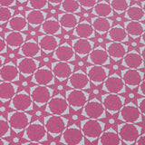 Wallpaper detail in a floral lattice print in cream on a magenta field.
