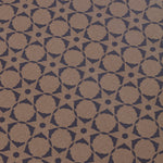 Wallpaper detail in a floral lattice print in navy on a kraft brown field