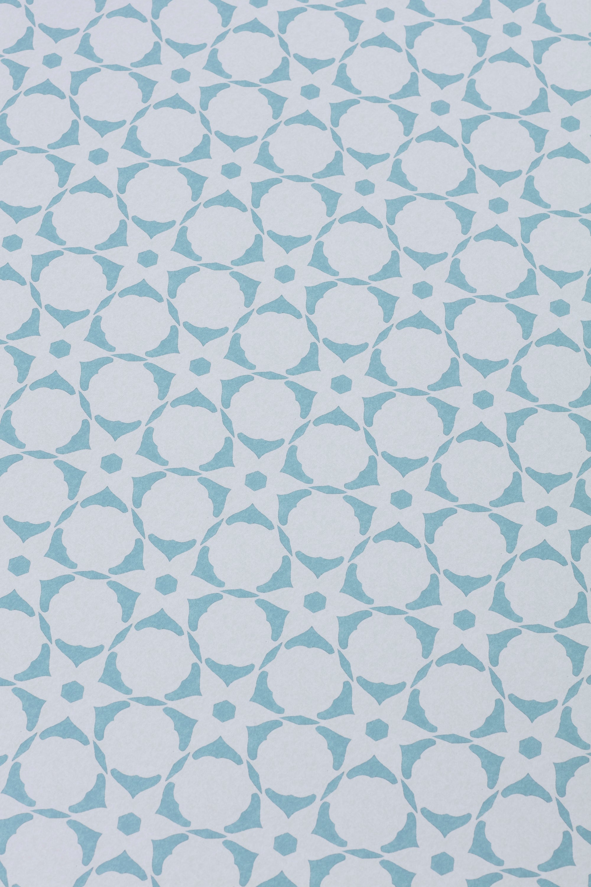 Wallpaper detail in a floral lattice print in powder blue on a cream field