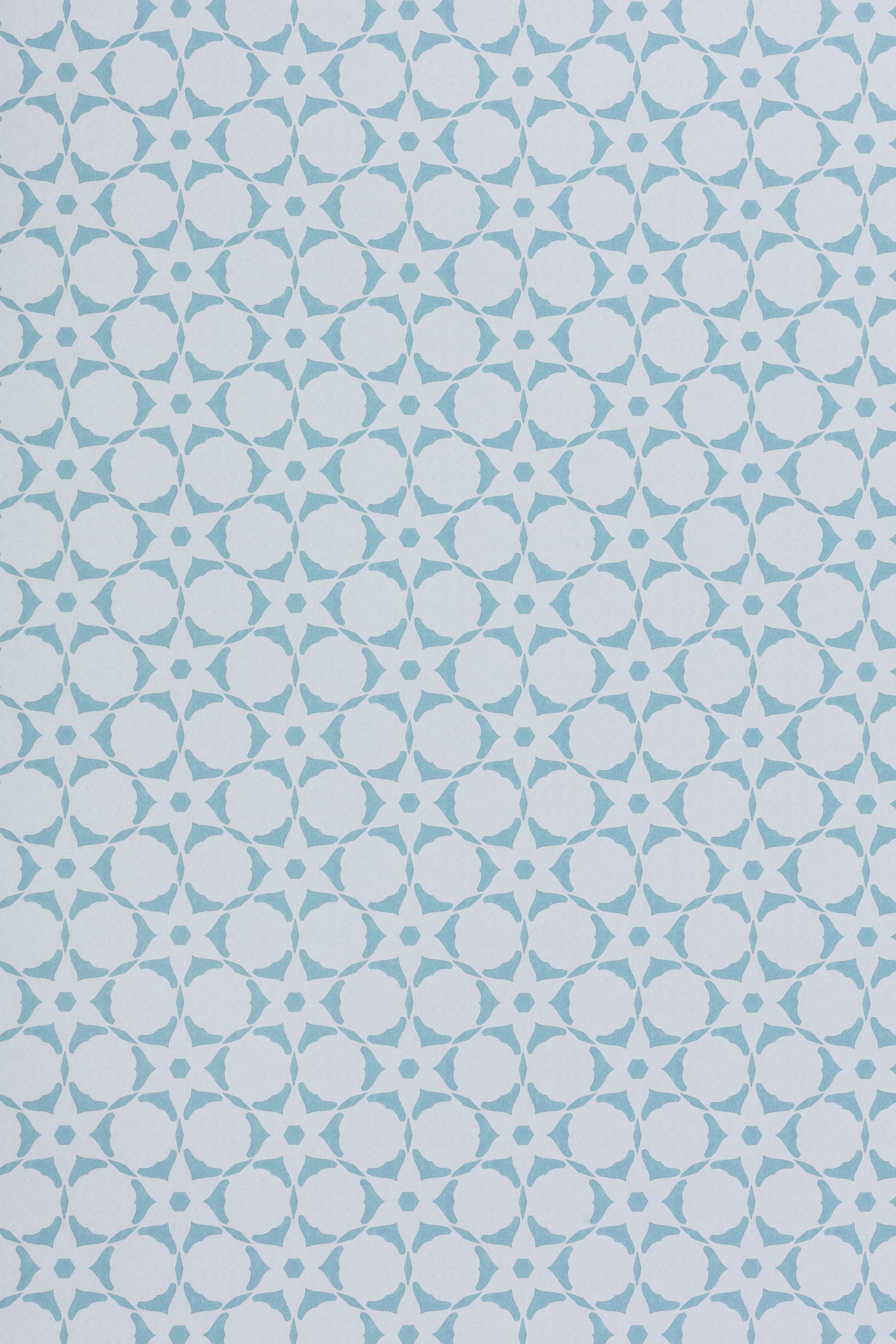 Wallpaper in a floral lattice print in powder blue on a cream field