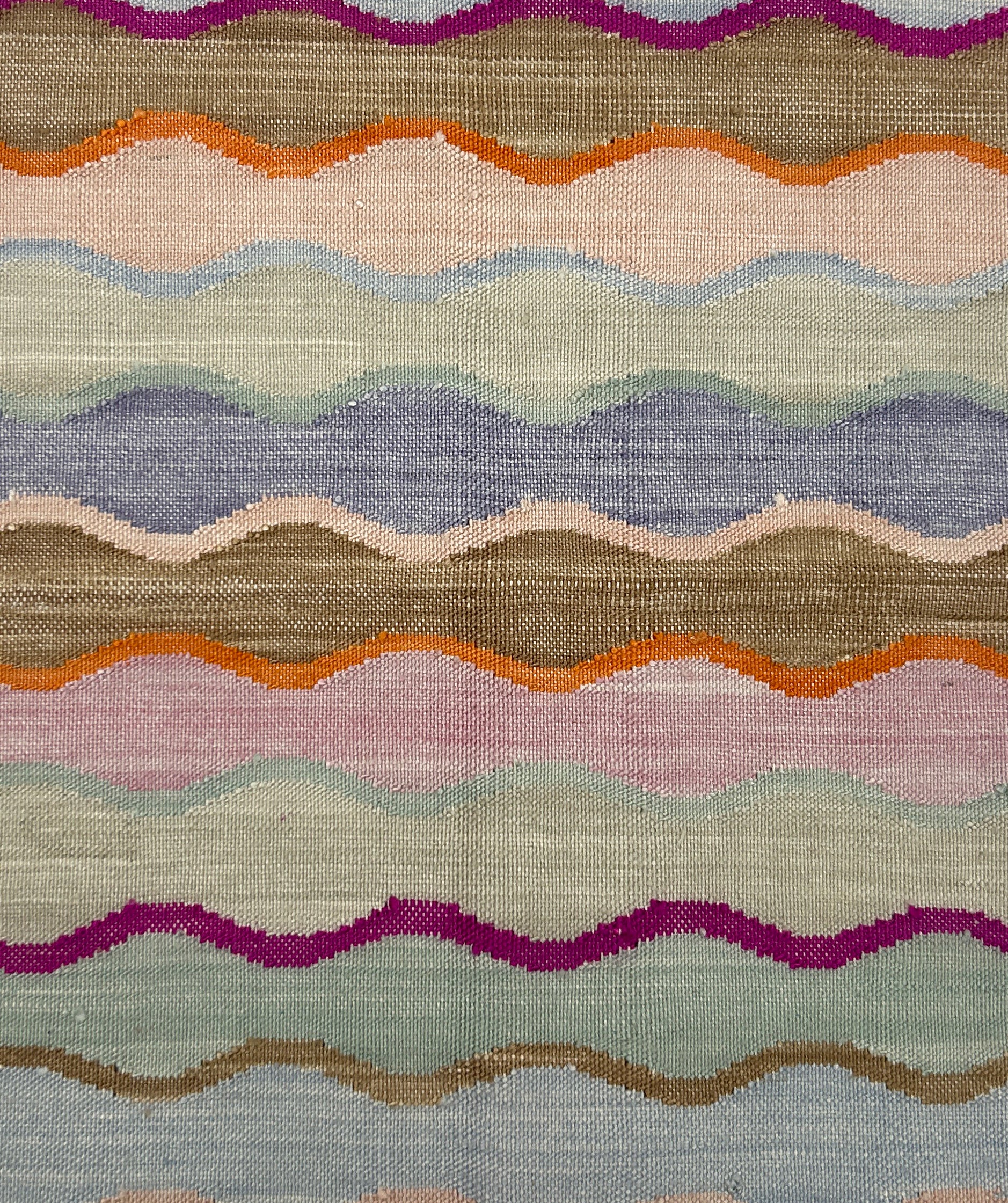 Multicolored wavy patterned rug with various colors.