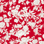 Detail of wallpaper in a classic floral print in tan and white on a red field.