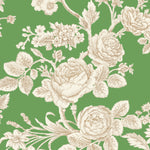 Detail of wallpaper in a classic floral print in tan and white on a green field.