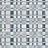 Detail of fabric in a large-scale checked pattern in shades of cream and blue.