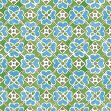 Detail of wallpaper in a floral lattice print in blue, green, brown and white.