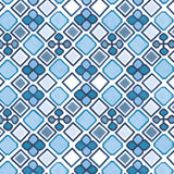 Detail of wallpaper in a geometric diamond and floral print in shades of blue, navy and white.