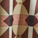 Draped wallpaper yardage in a geometric grid print in shades of brown, red, purple and black on a white field.