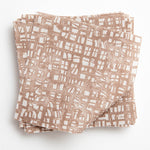 A stack of fabric swatches in a textural wicker pattern in mottled brown on a white field.