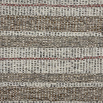 Handwoven carpet in a mixed width stripe in white, brown, charcoal and rust. 