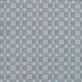 Flatweave rug in a small scale decorative lattice design in cream on a pale grey field.