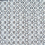 Flatweave rug in a small scale decorative lattice design in cream on a cool grey field. 