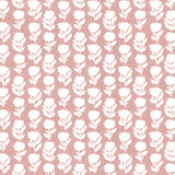 Detail of fabric in a classic floral silhouette print in cream on a pink field