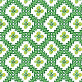 Detail of wallpaper in a playful floral grid print in green, yellow and blue on a white field.