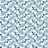 Detail of wallpaper in painterly diamond print in blue and navy on a white field.