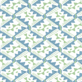 Detail of wallpaper in painterly diamond print in blue and green on a white field.