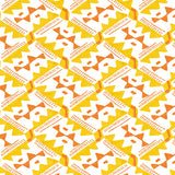 Detail of wallpaper in painterly diamond print in yellow and orange on a white field.