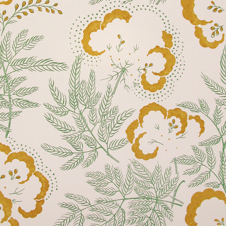 Detail of wallpaper in an intricate floral print in mustard yellow and green on a cream field.