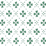 Detail of wallpaper in a dainty floral lattice print in green on a white field.