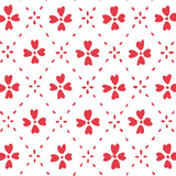 Detail of wallpaper in a dainty floral lattice print in red on a white field.