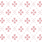 Detail of wallpaper in a dainty floral lattice print in light pink on a white field.