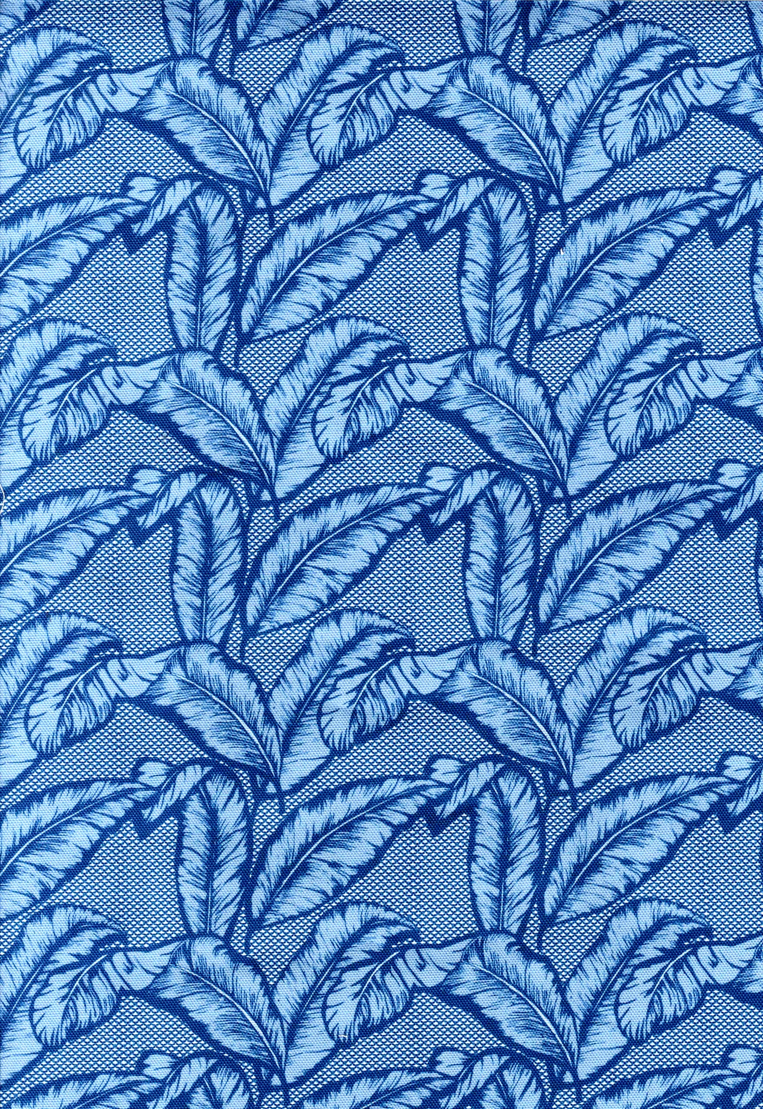 Detail of fabric in a dense leaf print in navy and blue on a blue field.