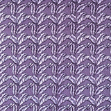 Detail of fabric in a dense leaf print in shades of purple on a purple field.