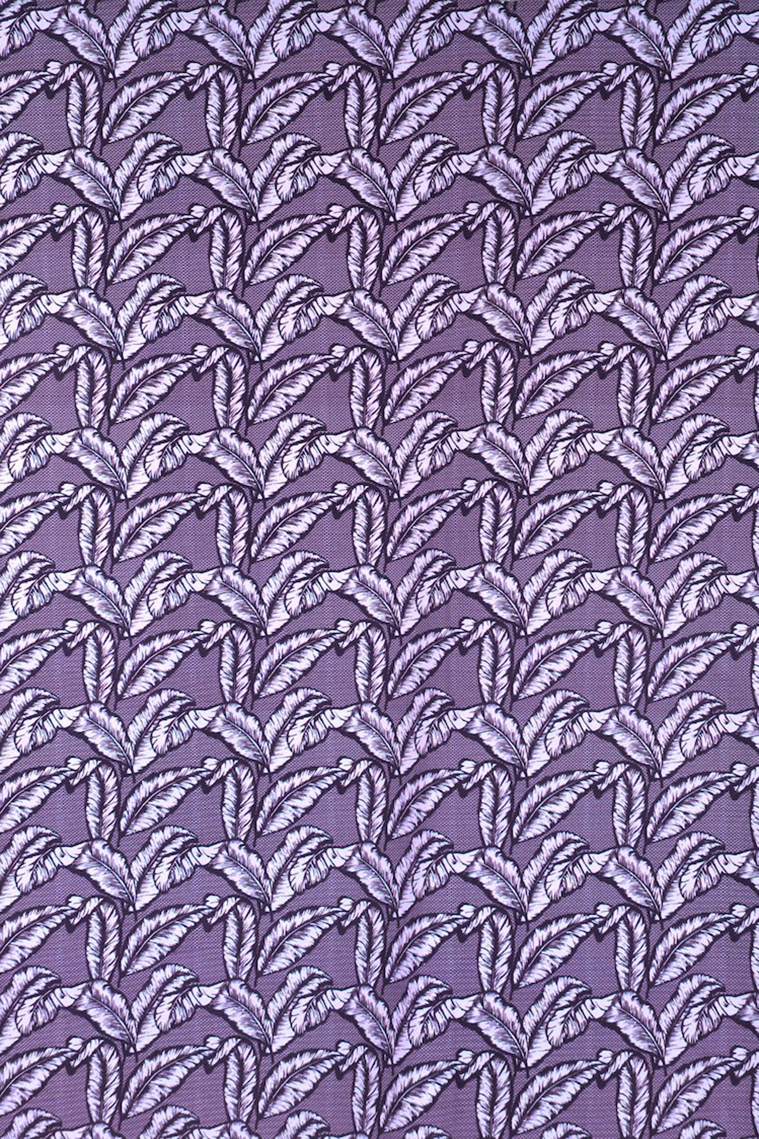 Detail of fabric in a dense leaf print in shades of purple on a purple field.