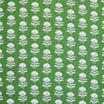 Detail of fabric in a repeating thistle print in white and green on a green field.