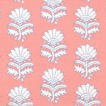Detail of fabric in a repeating thistle print in white and blue on a pink field.