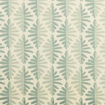 Detail of fabric in a fern leaf print in shades of green on a cream field.