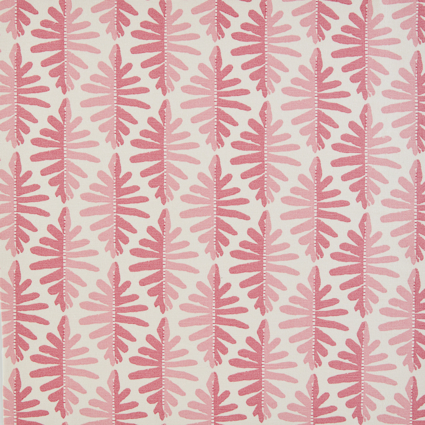 Detail of fabric in a fern leaf print in shades of pink on a white field.