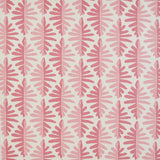 Detail of fabric in a fern leaf print in shades of pink on a white field.