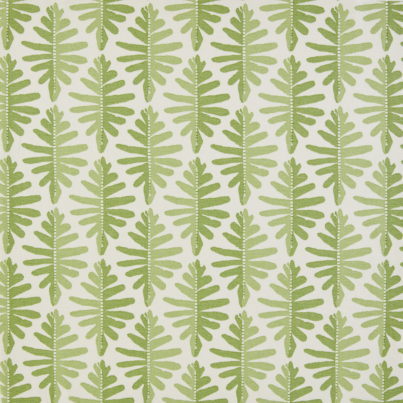 Detail of fabric in a fern leaf print in shades of green on a white field.