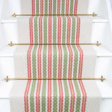 Striped flatweave runner in green and pink on white staircase