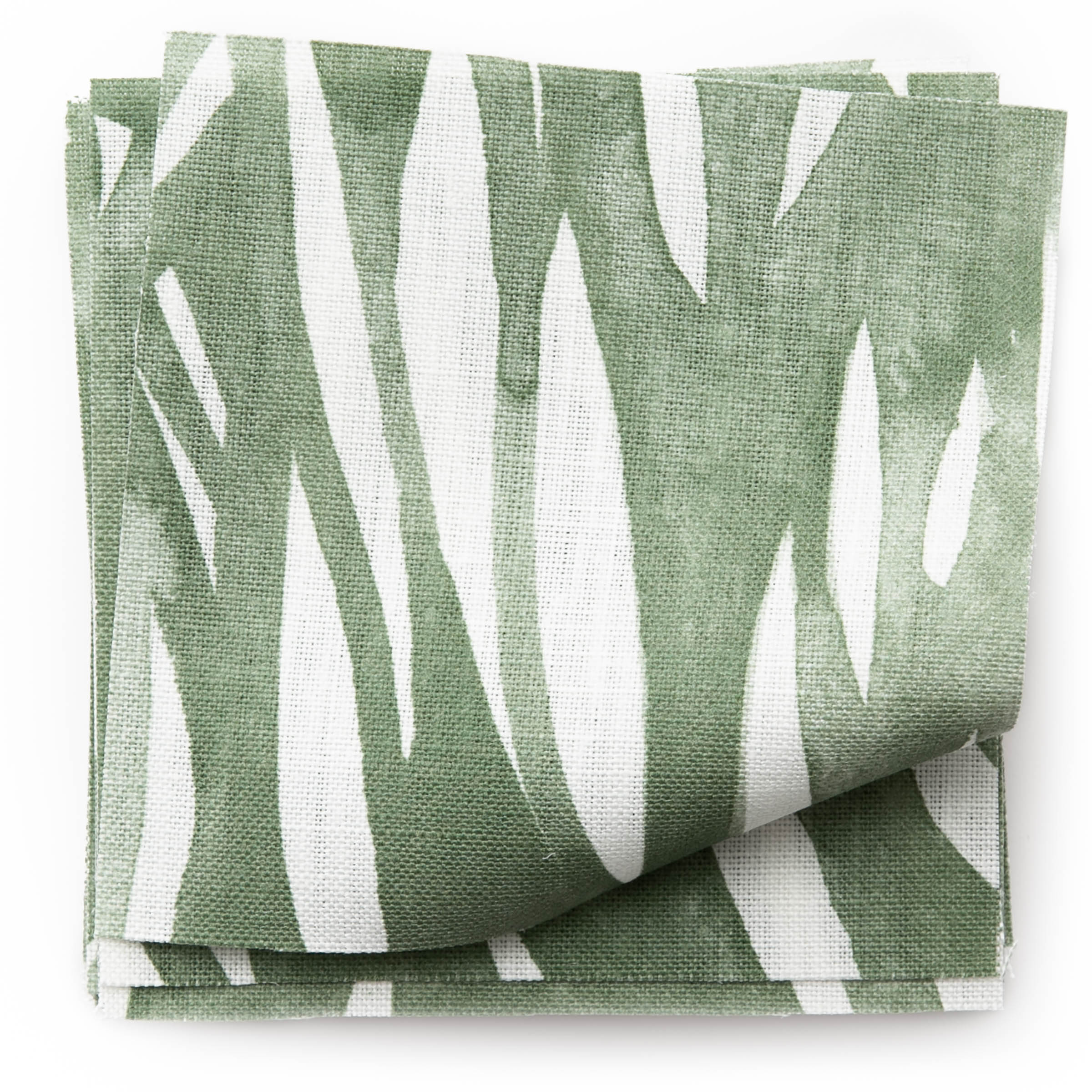 A stack of fabric swatches in an abstract leaf pattern in white on a green watercolor field.