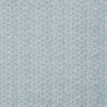 Detail of a linen fabric in a detailed geometric pattern in white on a light blue field.