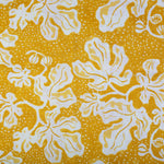 Detail of wallpaper in a playful botanical print in yellow and white on a bright yellow field.