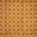 Detail of fabric in a repeating geometric print in cream on an ochre field.
