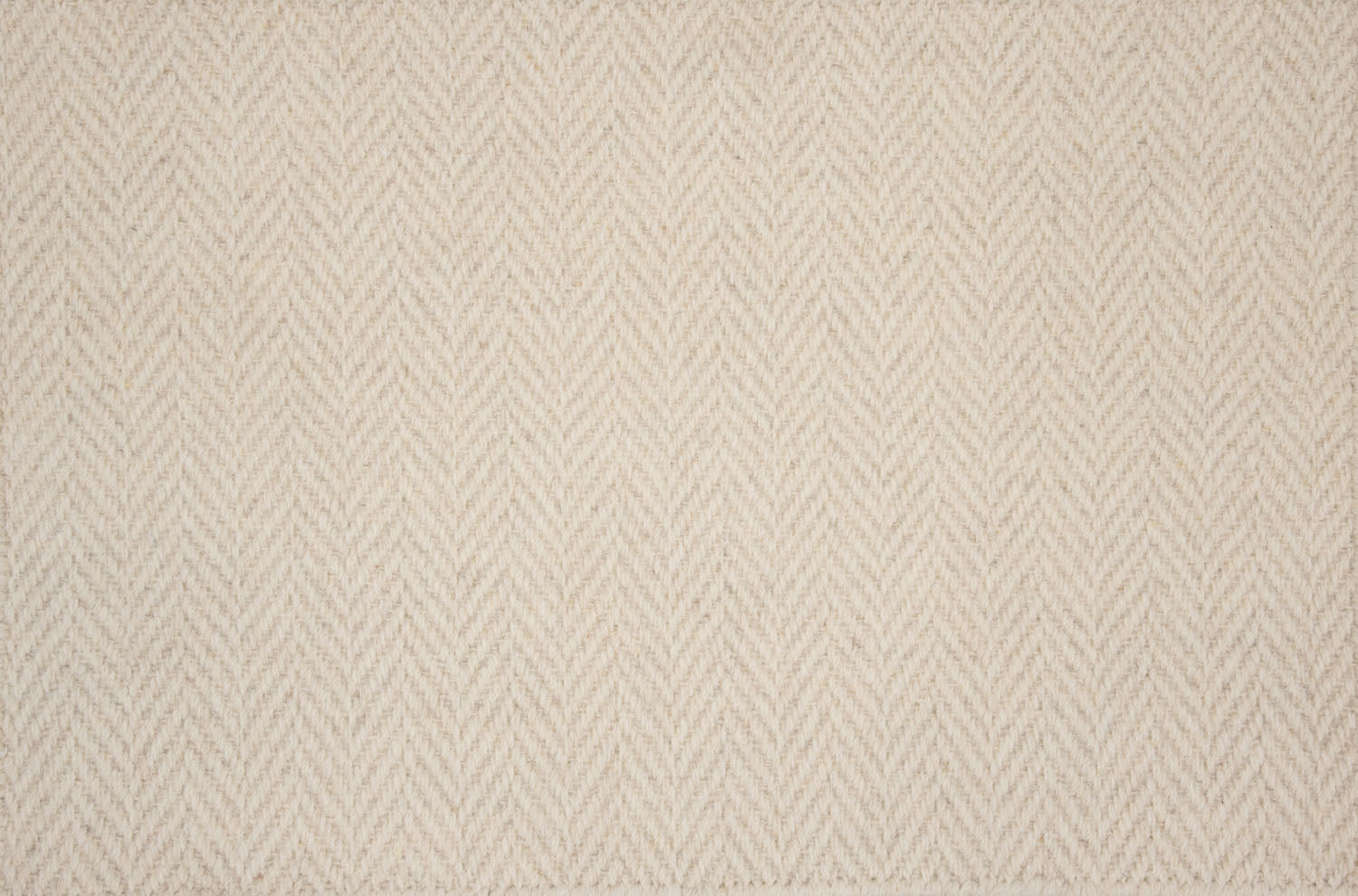 Broadloom carpet in a herringbone pattern in beige.