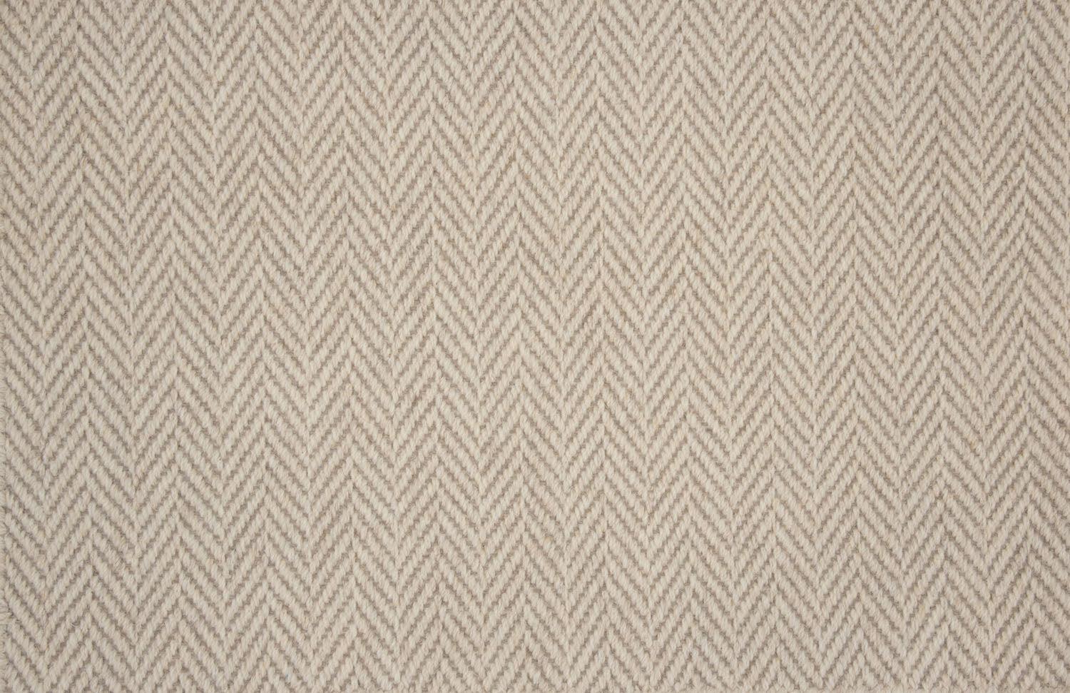 Broadloom carpet in a herringbone pattern in taupe. 