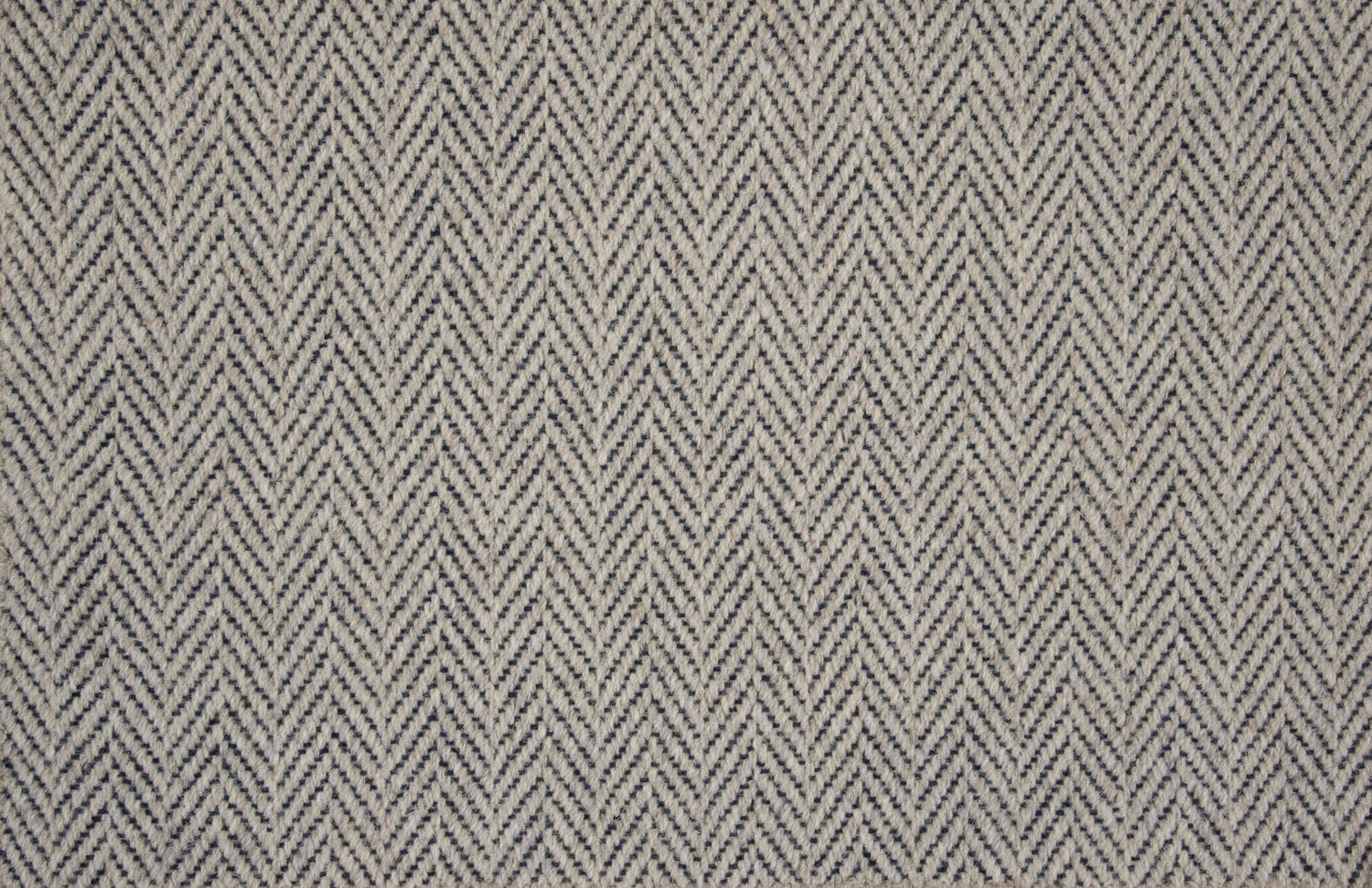 Broadloom carpet in a herringbone pattern in navy blue and grey.