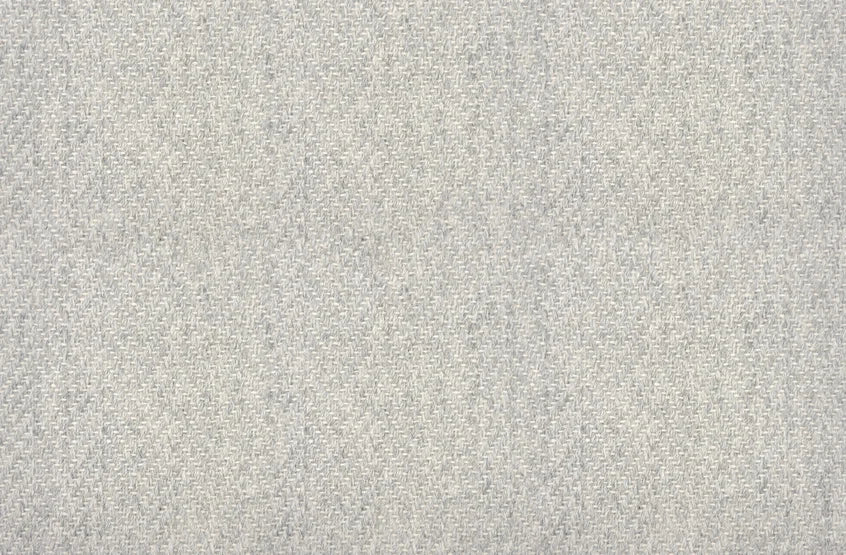 Broadloom carpet in a herringbone pattern in pale grey.