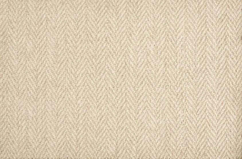 Broadloom carpet in a herringbone pattern in light tan. 